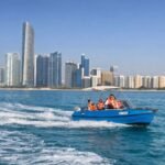 Blue self drive speed boat rental in Abu Dhabi near the city skyline