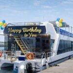 Lavy yacht during daytime decorated with balloons and a “Happy Birthday to You” sign, ideal for birthday yacht rental and special occasions