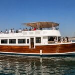 Ocean Majesty luxury party boat in Abu Dhabi with spacious outdoor deck and elegant wooden exterior.