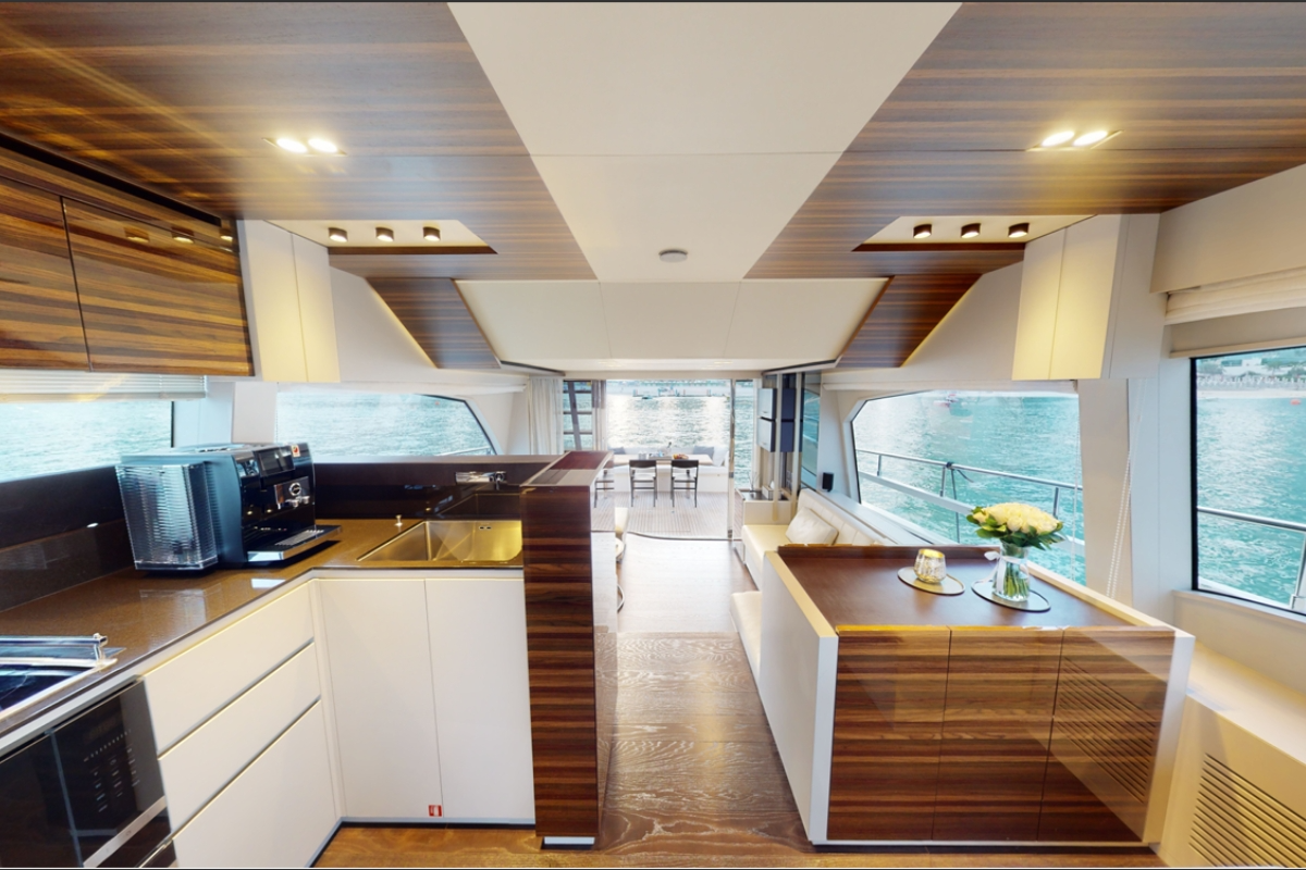 Sophisticated interior salon of the Ferretti 670 F1 trackside yacht charter featuring premium speakers.