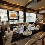 Amber Regent yacht rental dining table set for about 8 guests, Yas Marina, Abu Dhabi