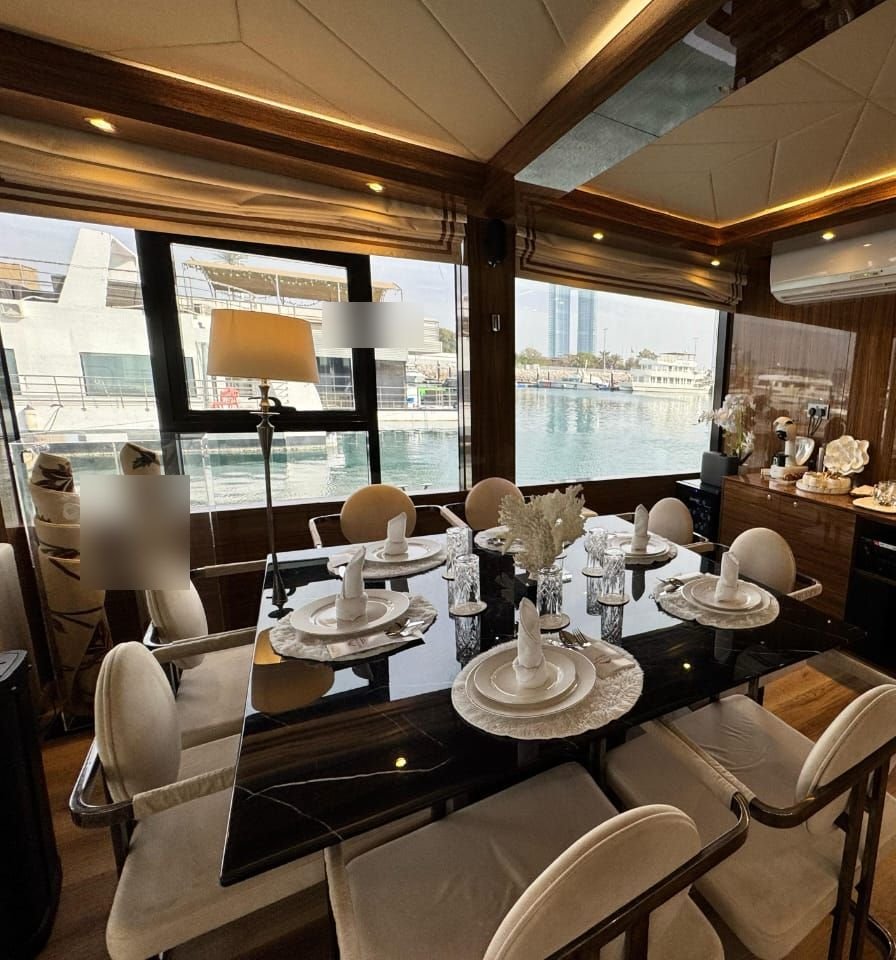 Amber Regent yacht rental dining table set for about 8 guests, Yas Marina, Abu Dhabi