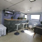 Butinah Boat main lounge with sofas and TV