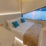 Celestia yacht rental cabin with double bed and panoramic window, Yas Marina, Abu Dhabi