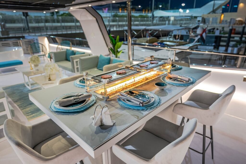 Celestia yacht rental dining table with built-in fire feature, Yas Marina, Abu Dhabi