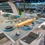 Celestia yacht rental dining table with built-in fire feature, Yas Marina, Abu Dhabi
