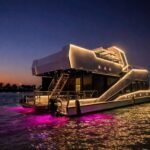 Celestia yacht rental lit up at night with LED outline and underwater lights, Yas Marina, Abu Dhabi