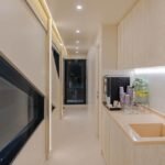 Celestia yacht rental light-wood corridor and drinks station, Yas Marina, Abu Dhabi